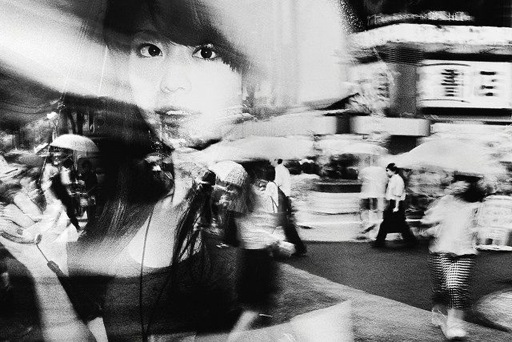 Woman seen from the reflection of glass 