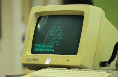 Image depicts an older computer with a birthday cake on it