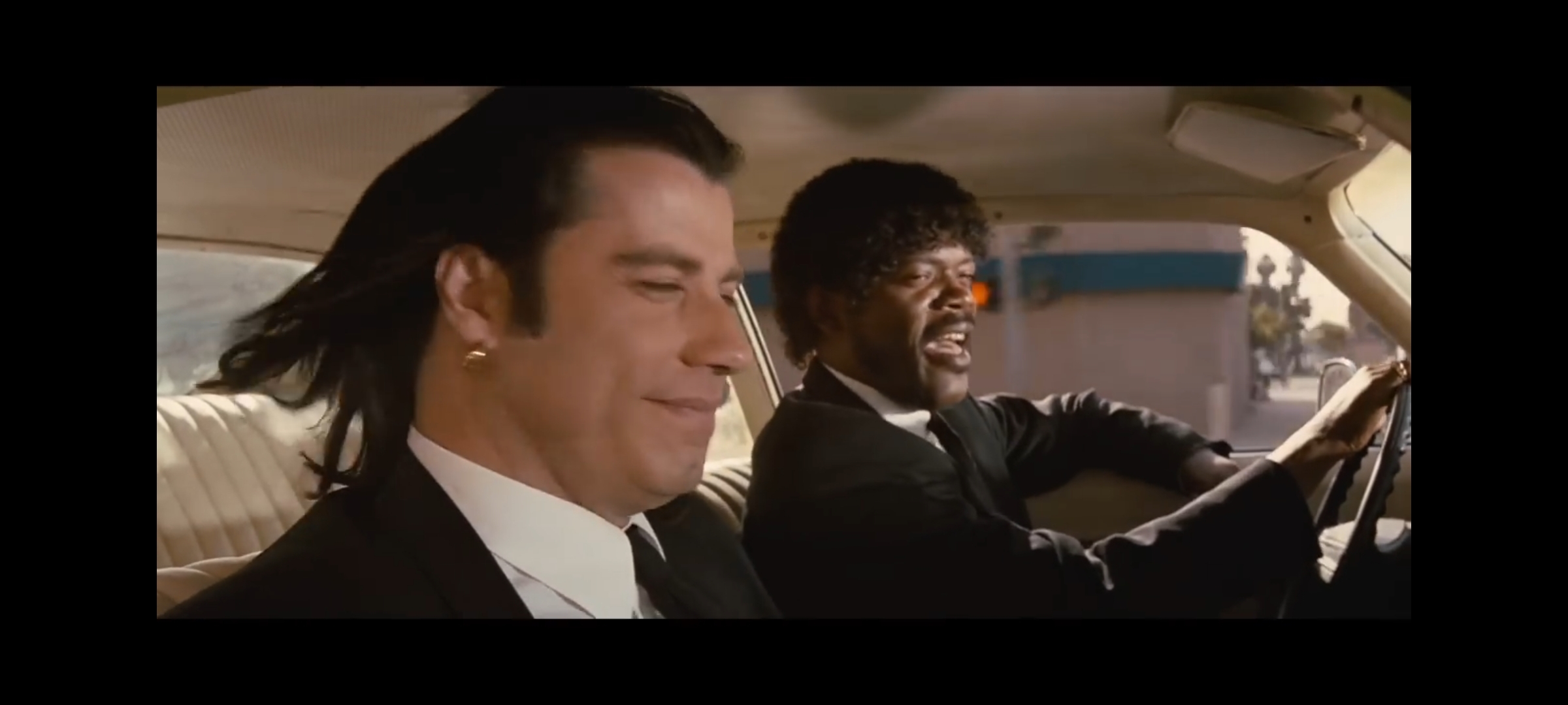 A screenshot of the scene in Pulp Fiction where John Travolta is telling Samuel L Jackson about the little differences between America and Europe