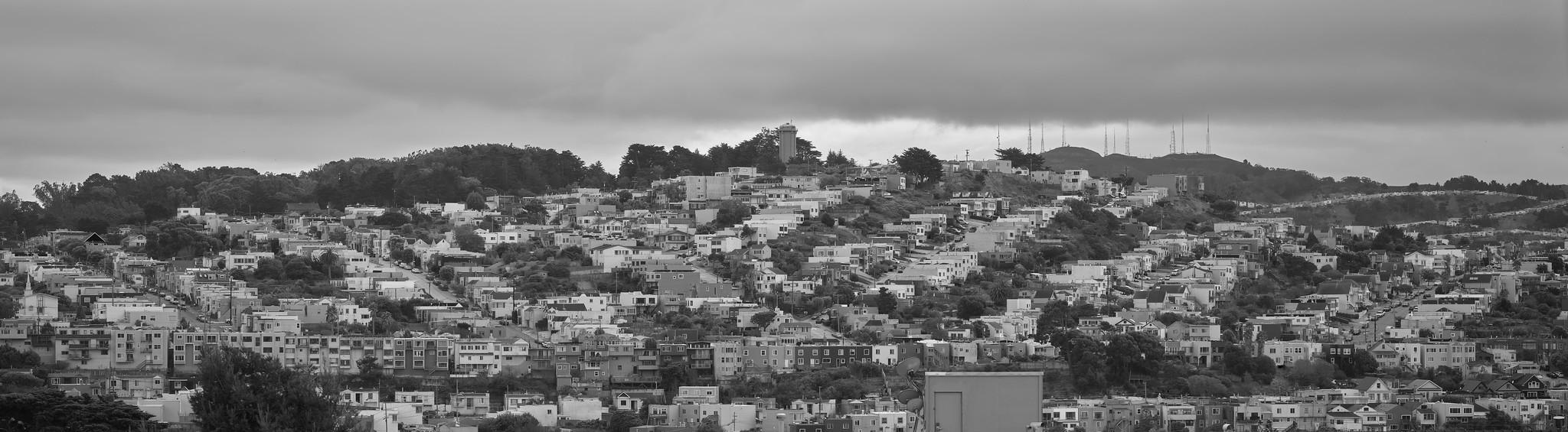 A panoramic view of a hillside in San Francisco, covered in small mod-century residential houses.