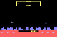 Screenshot of Defender for the Atari 2600 with a spaceship flying around with blocky pixel graphics