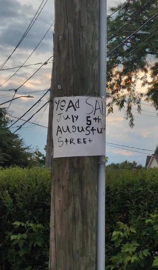 Yard sale sign on a light post misspelled as &quot;Yead Sale&quot;.