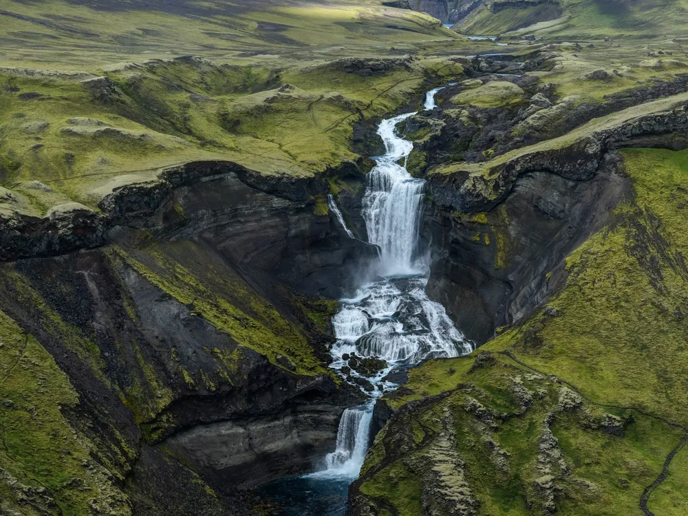 Image of a waterfall. The Ofaerufoss waterfall is part of the Nyrdri-Ofaera River, meaning the “impassable northern river.” The river flows into Eldgja, or the “Canyon of Fire.” Andro Loria, Iceland, 2017
