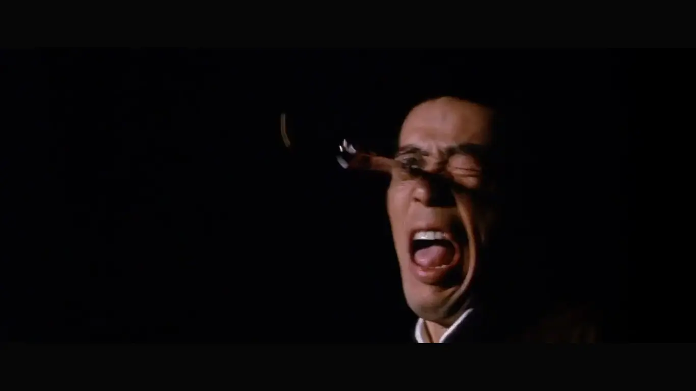 Screenshot of the film The Street Fighter - character with knife in eye
