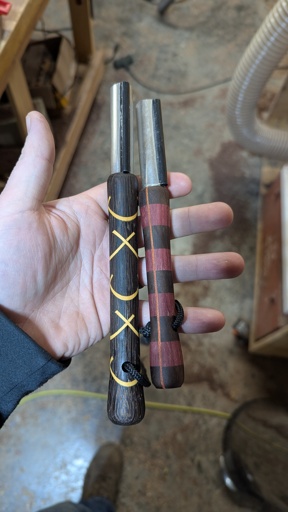 Two beautiful turned handle flint fire strikers.